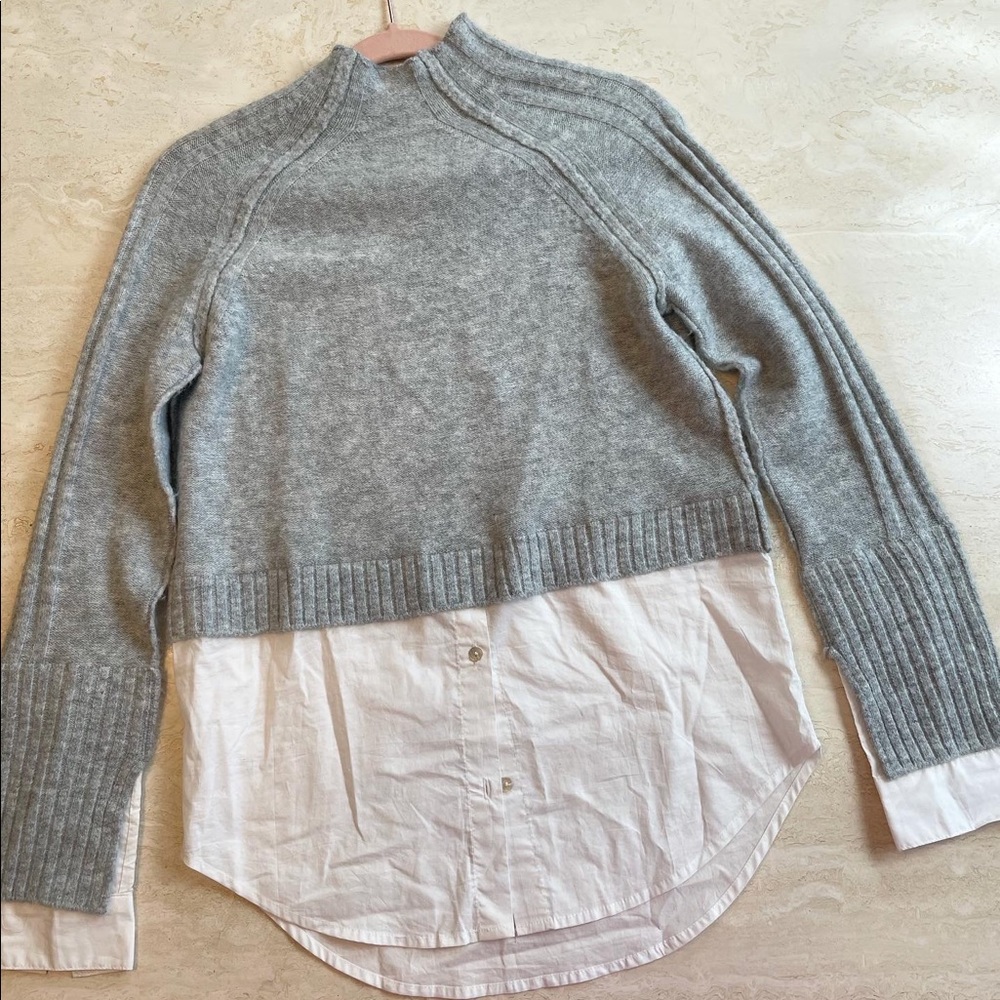 Sweater with shirt insert.